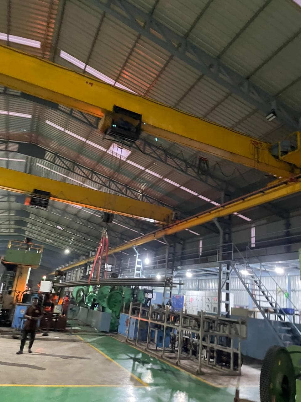 Forging area with cranes and handling equipment in operation.