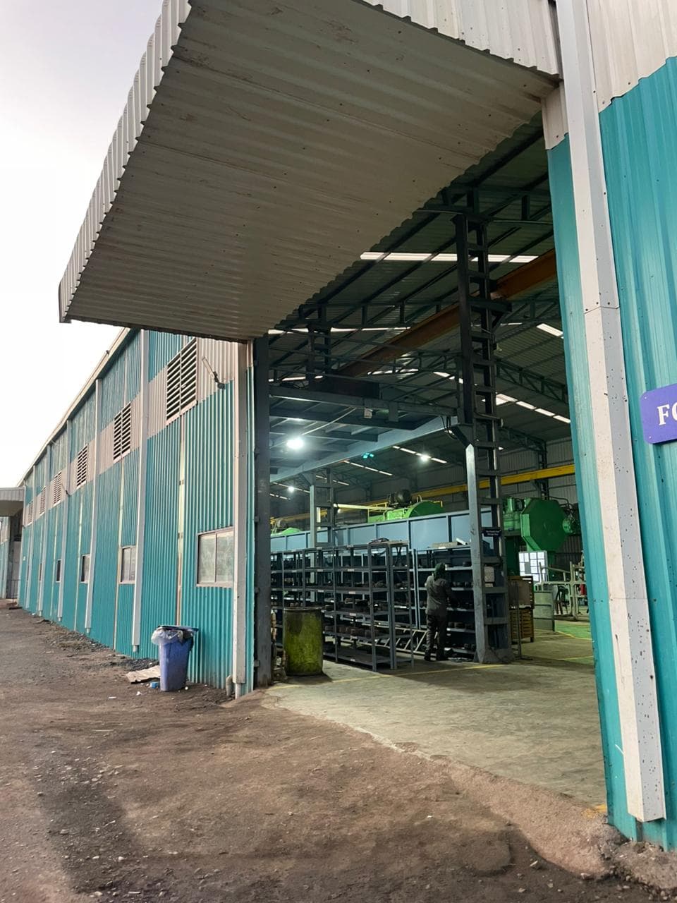 Wide shot of manufacturing facility showing multiple process zones.