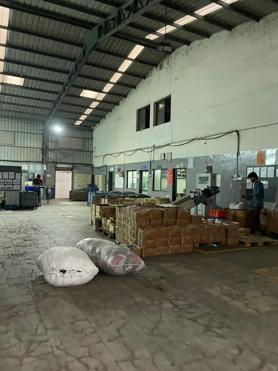 Mid-aisle perspective of production cells and safety markings.