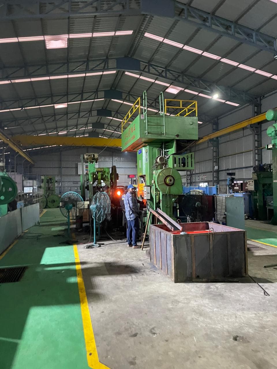 Evening shot of the production floor highlighting activity levels.